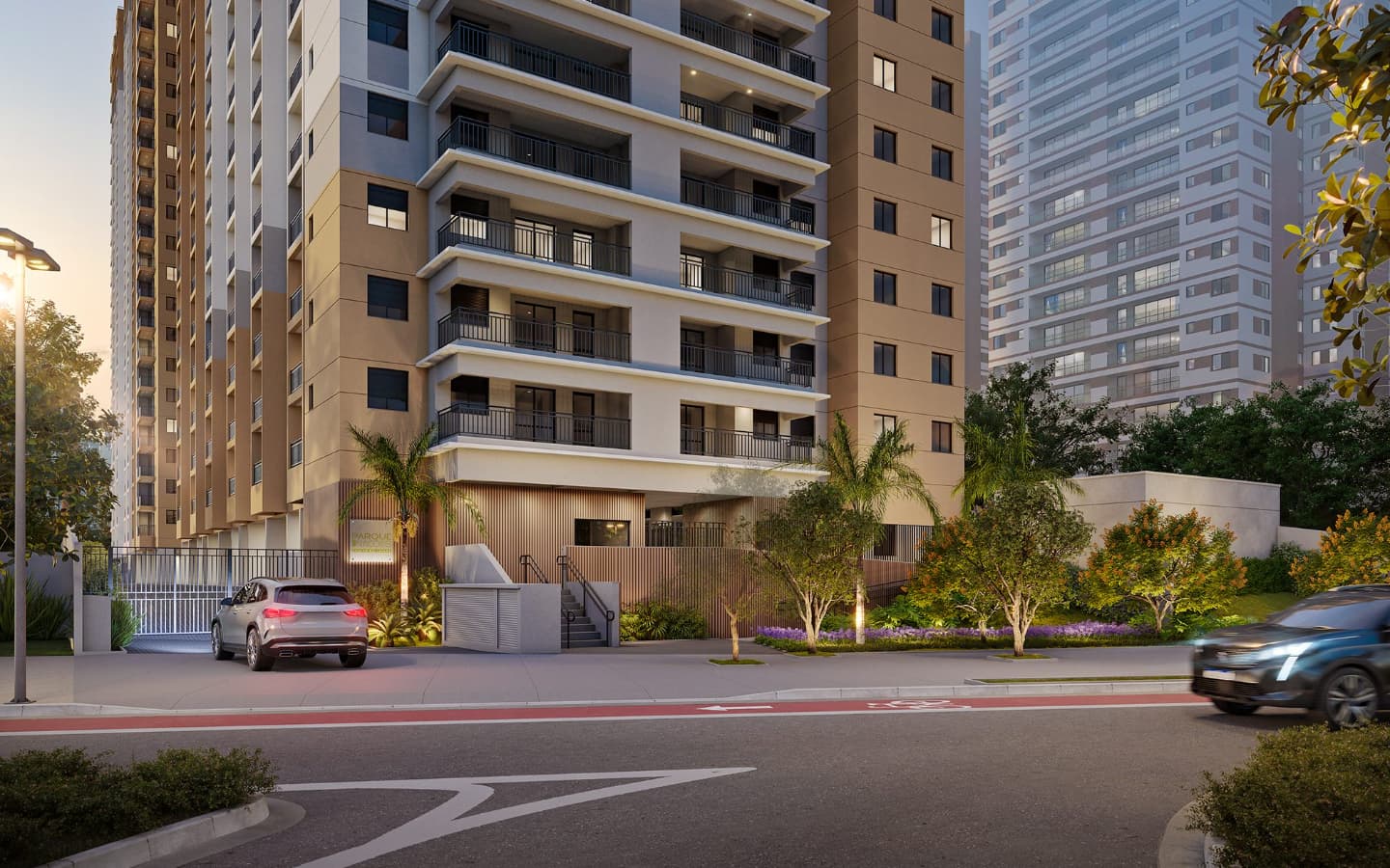 Fachada externa do edifício residencial com portaria e carros na rua