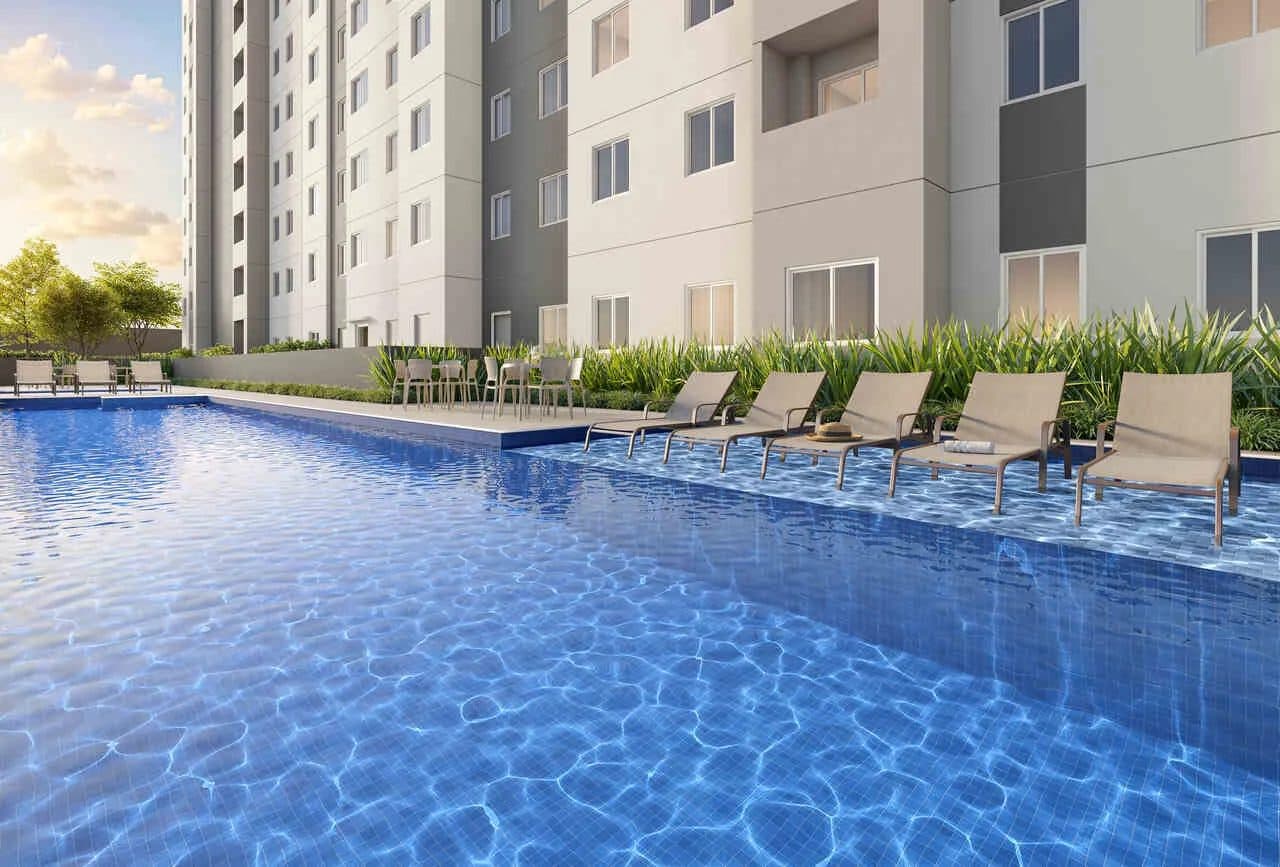 Piscina ao ar livre com espreguiçadeiras e área de descanso.